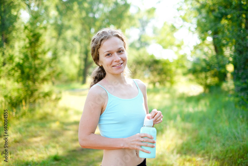 Drinking water, fitness and exercise woman after sports run and training in nature. Workout, hiking and walking challenge with a bottle of a female runner in summer ready for running for health