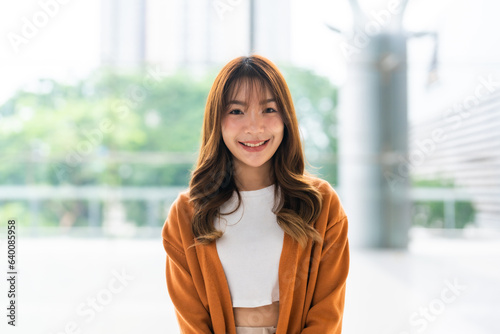 Free Download Portrait of young beauty asian woman smiling and looking at camera, standing in building modern tower - GFXLoad