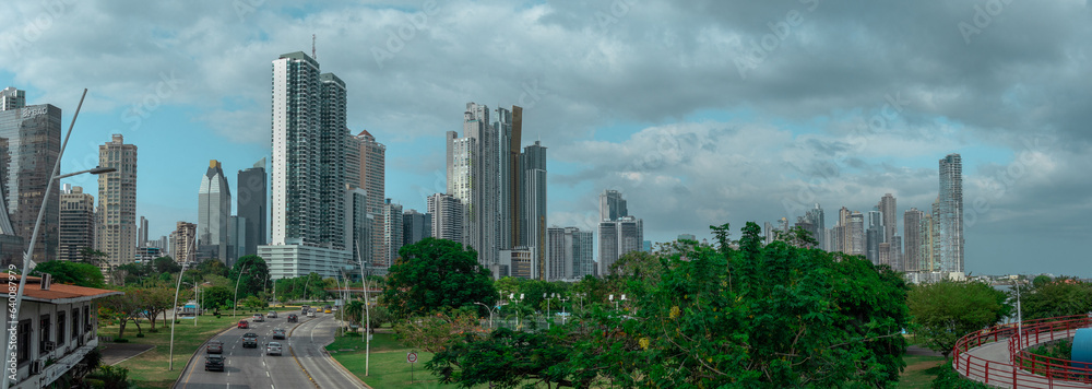 Obraz premium Cityscape of Panama downtown with visible high skyscrapers and business houses, looking from across the highway overpass with cars rushing under.