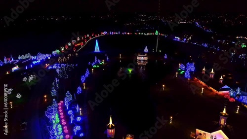 Aerial View of a Large Christmas Display With Barns, Trees, Shrubs, a Pond, all Lit up, for a Drive Thru photo