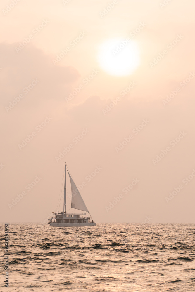 Sail boat in Mirissa Sri Lanka under the sun during sunset