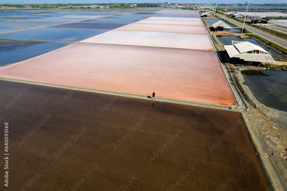 Aerial photo of person walking in salt flats textures in Phetchaburi, Thailand