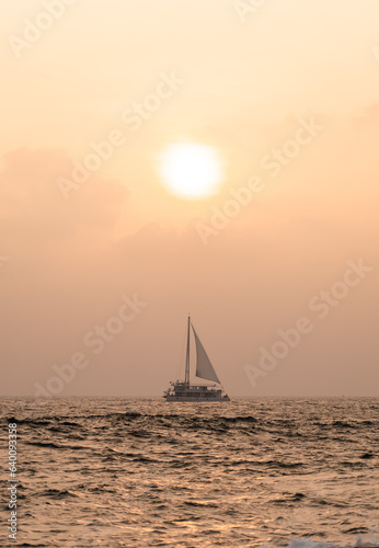 Sail boat in Mirissa Sri Lanka under the sun during sunset