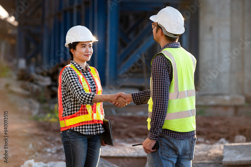 construction site Workers and engineers of various nationalities are discussing plans. Two construction workers working together while visiting expressway construction