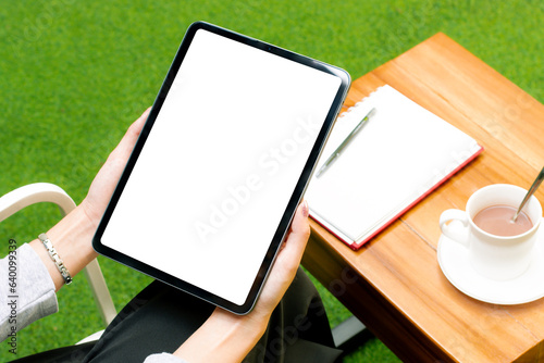 Blank screen tablet white background in woman hand for advertising text and copy space. Working from anywhere concept.
 photo