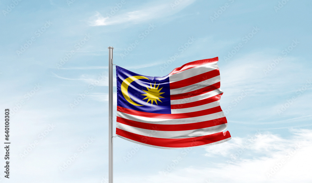 Malaysia national flag waving in beautiful sky. The symbol of the state on wavy silk fabric.