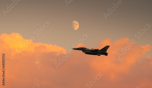 Obraz na płótnie Bucharest International Air Show. F16 military fighter airplane flying under the moon. Military aviation aircrafts and war missiles industry. w salonie