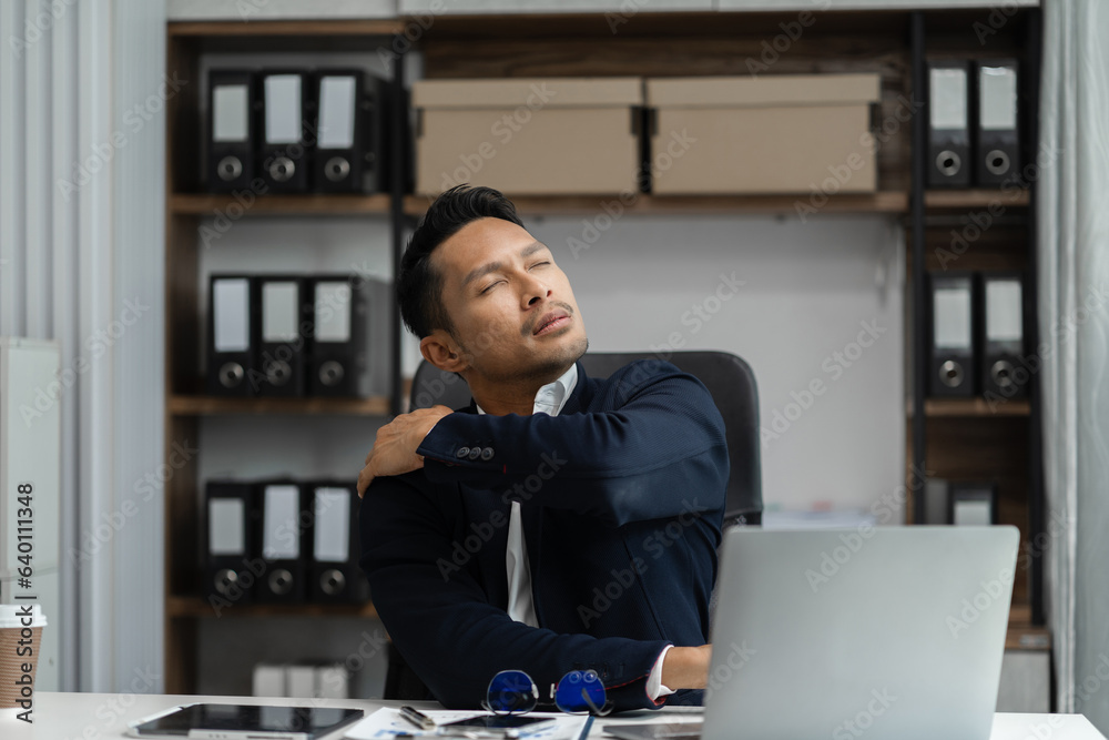 Male businessman is doing a stretchy posture due to sitting in the office for too long, office syndrome concept. Male businessman is doing a stretchy posture due to sitting in the office for too long, office syndrome concept.