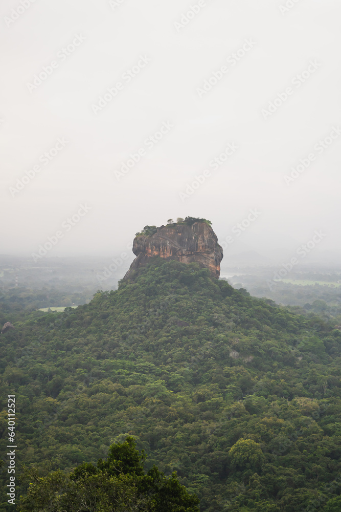 Hazy and moody morning photo of Sigiriya Lion Rock from Pidarangula Rock