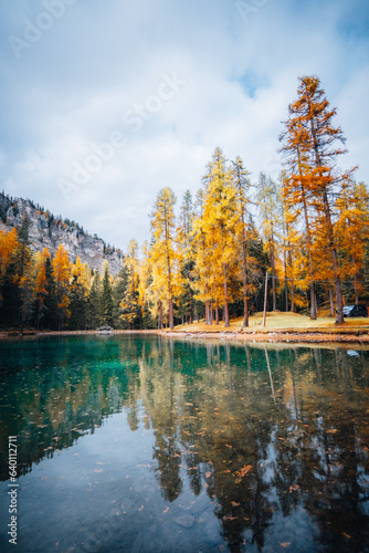 Autumn trees and lake view of Lago Ghedina, The Dolomites South Tyrol Italy