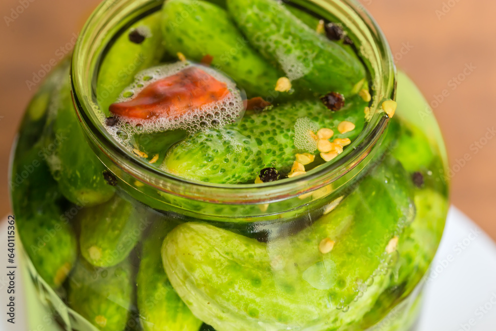 Quick pickled cucumbers in jar, view through the jar neck Quick pickled cucumbers in jar, view through the jar neck