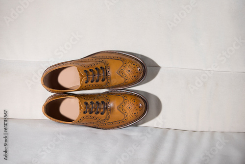 Tanned Brogue Derby Shoes Made of Calf Leather with Rubber Sole Isolated on Sofe