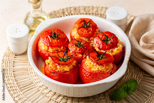 Mediterranean dinner. Casserole with oven baked stuffed tomatoes with rice, cheese and basil.