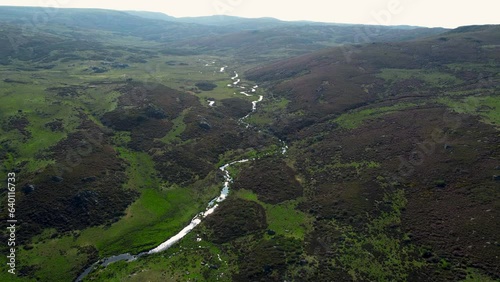 sierra segundera river winds through hillside landscape, drone aerial dolly photo