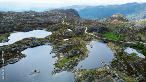 Panoramic aerial overview above presa los garandones winding road and calm alpine lakes photo
