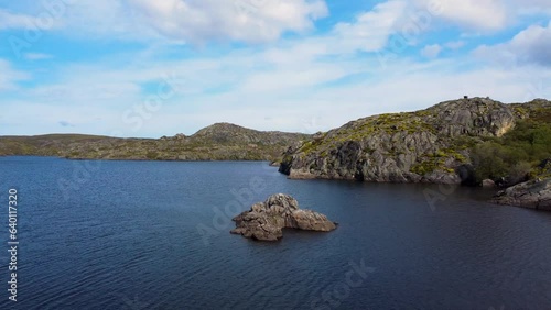 Aerial dolly above stunning granite exposed rocky islands in lake of spain photo