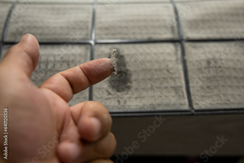   Man hand hold air conditioner filter for Cleaning air conditioner.
