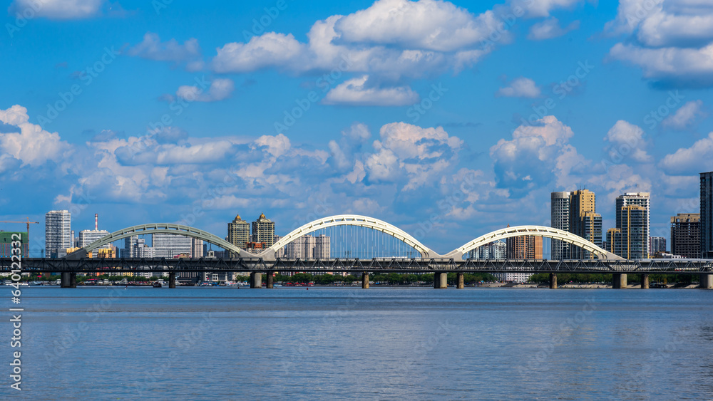 Harbin Songhuajiang Highway Bridge. Cityscape of Harbin, China. Bridge with blue sky and white clouds in sunny day. 