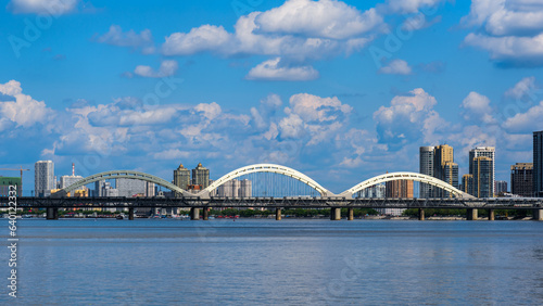 Harbin Songhuajiang Highway Bridge. Cityscape of Harbin, China. Bridge with blue sky and white clouds in sunny day.  © YOUMING VISION