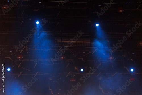 Fototapeta Naklejka Na Ścianę i Meble -  An empty concert stage illuminated by spotlights and smoke before the show.