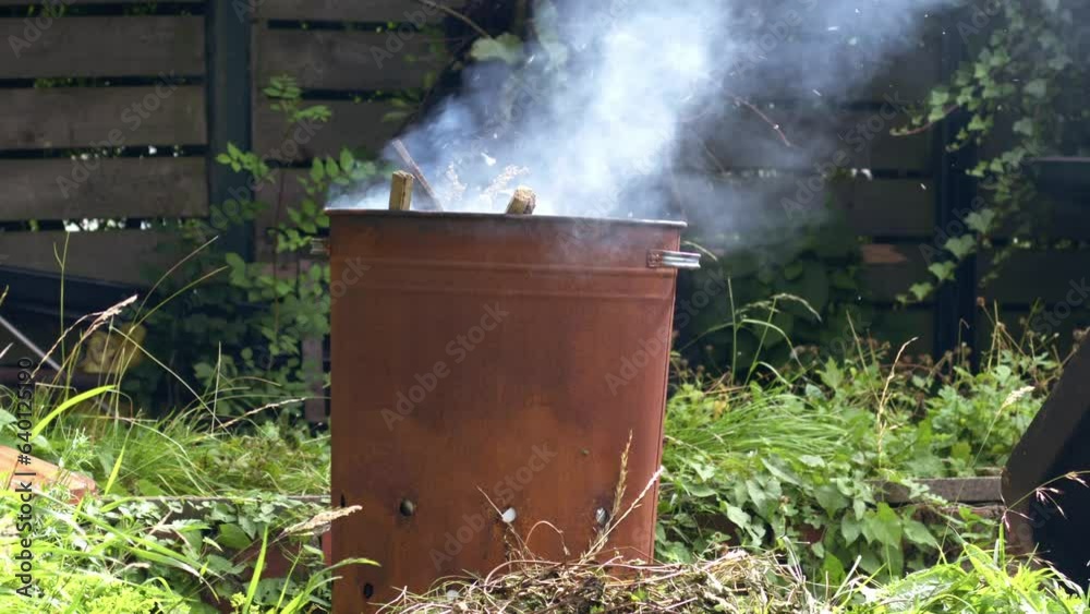 Garden and house garbage burning in a bin incinerator Garden and house garbage burning in a bin incinerator