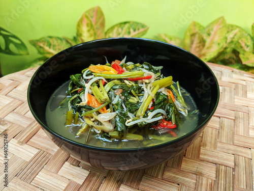 Cah kangkung or tumis kangkung, stir fried water spinach, common asian vegetable dish