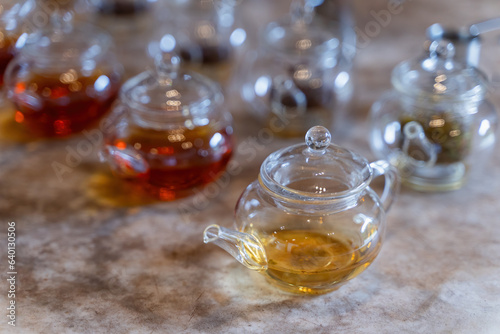 Hot tea in transparent glass on marble background. Glass cup of hot tea. Herbal tea in a cup