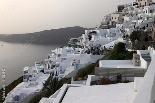 Whitewashed houses with terraces and pools and a beautiful view in Imerovigli on Santorini island, Greece photo