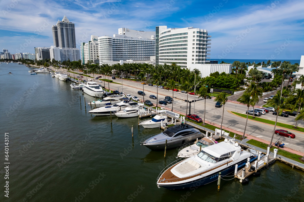 Miami Beach, Florida, USA - Yachts and other boats available for charter docked along Indian Creek Drive.
