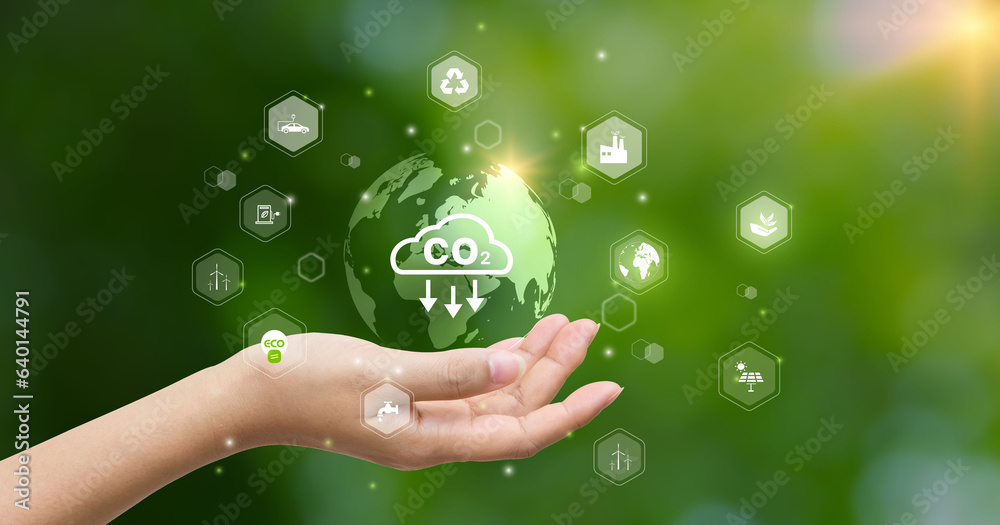 CO2 emission reduction concept.world icon in hand with environmental icons, Ideas for Sustainable development, and green business based on renewable energy. Energy saving, Sustainable development. CO2 emission reduction concept.world icon in hand with environmental icons, Ideas for Sustainable development, and green business based on renewable energy. Energy saving, Sustainable development.
