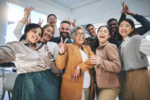 Happy, peace sign and portrait of business people in the office for team building or bonding. Smile, diversity and group of creative designers with manager having fun with goofy gesture in workplace.