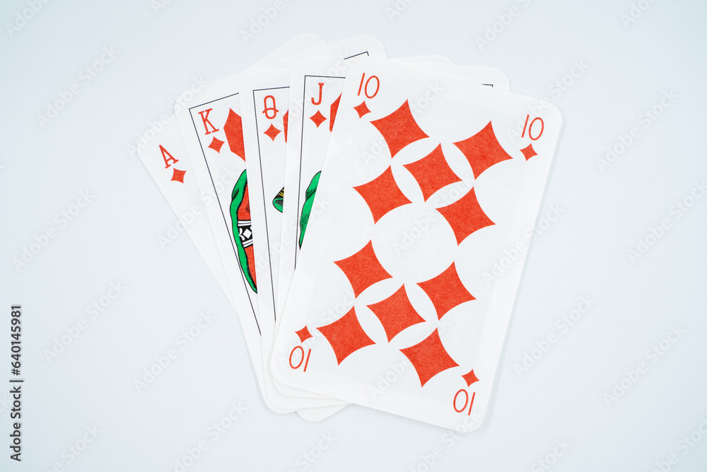 Royal straight flush playing cards poker hand in diamonds isolated on white background.