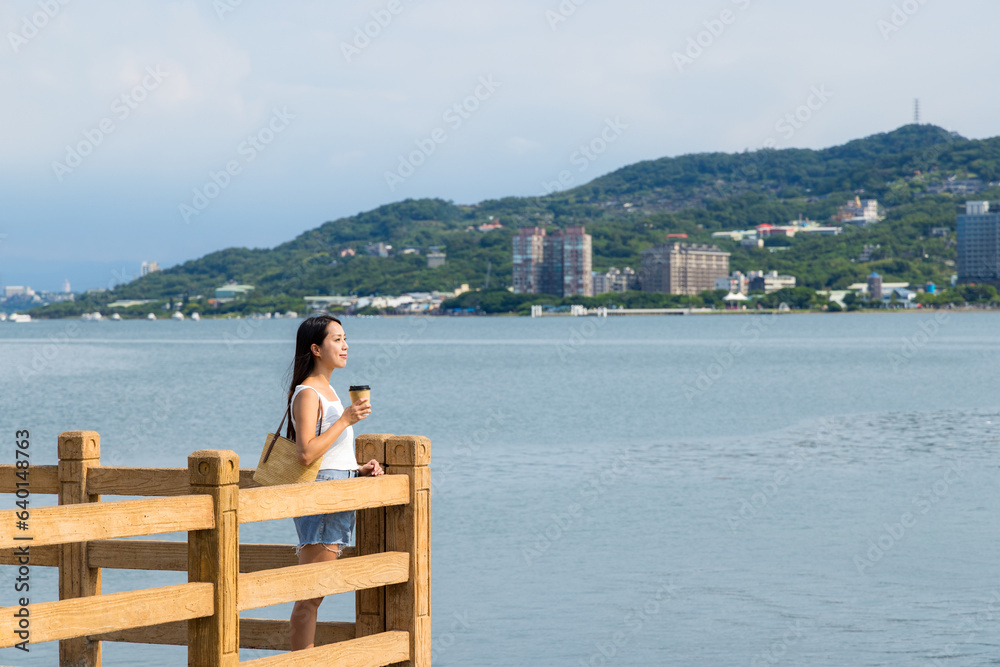 Woman hold with drink at Tamsui river waterfront