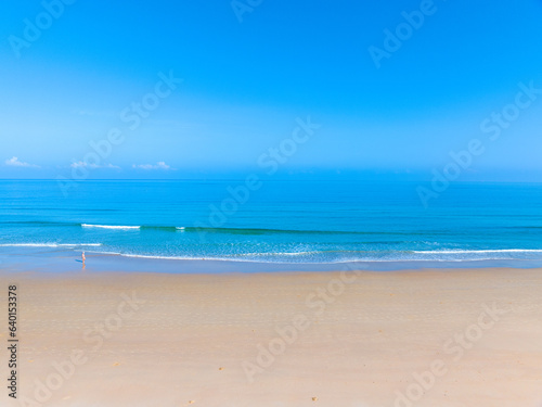 Summer sea nature background,Aerial view of Waves crashing on sandy shore,Sea surface ocean waves background © panya99