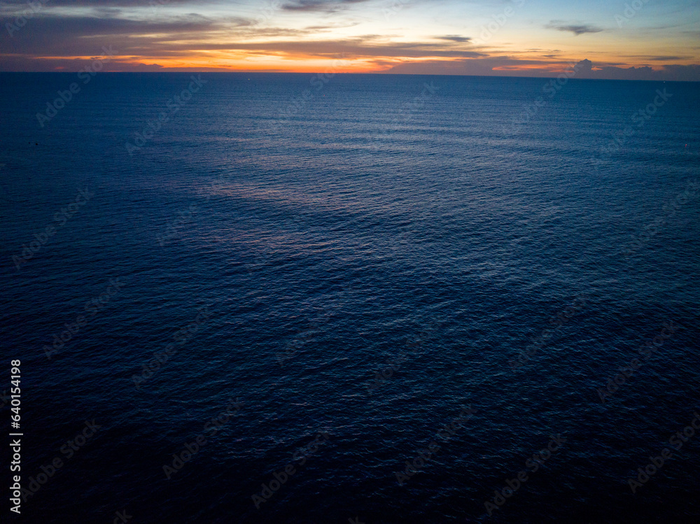 Obraz premium Aerial view sunset sky over sea,Nature Light Sunset or sunrise over ocean,Colorful dramatic scenery sky, Amazing clouds and waves in sunset sky beautiful light nature background