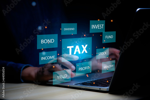 income tax concept. Businessman pointing to tax icon. income tax system icon around. pay online income tax. futuristic virtual screen interface technology.