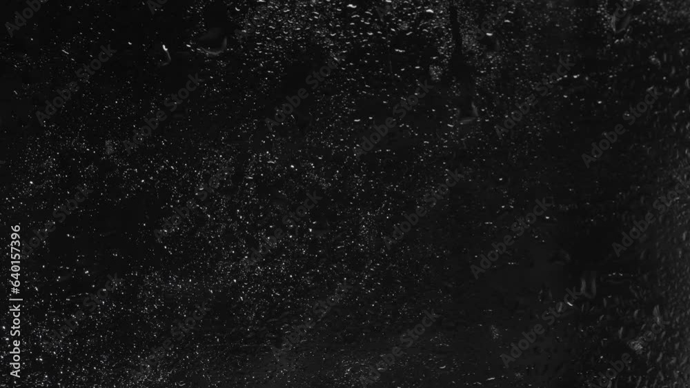 Raindrops on the window glass. Overlay template with black background.