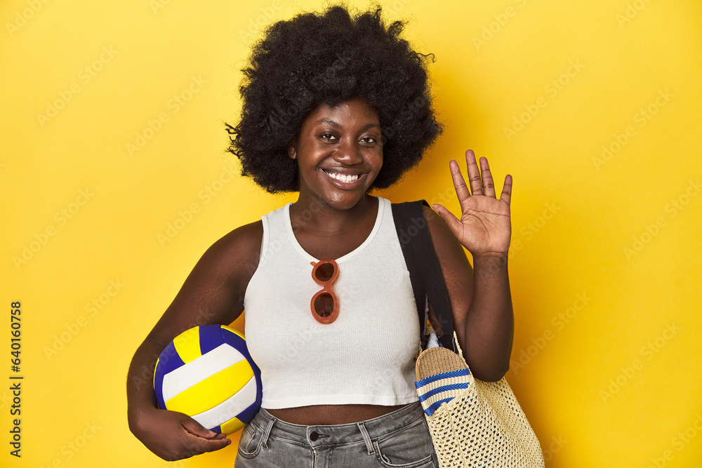Beach-ready woman with volleyball, ready for sport smiling cheerful showing number five with fingers. Beach-ready woman with volleyball, ready for sport smiling cheerful showing number five with fingers.