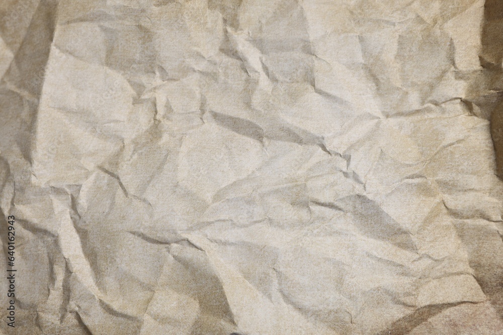Fototapeta premium Texture of crumpled parchment paper as background, top view