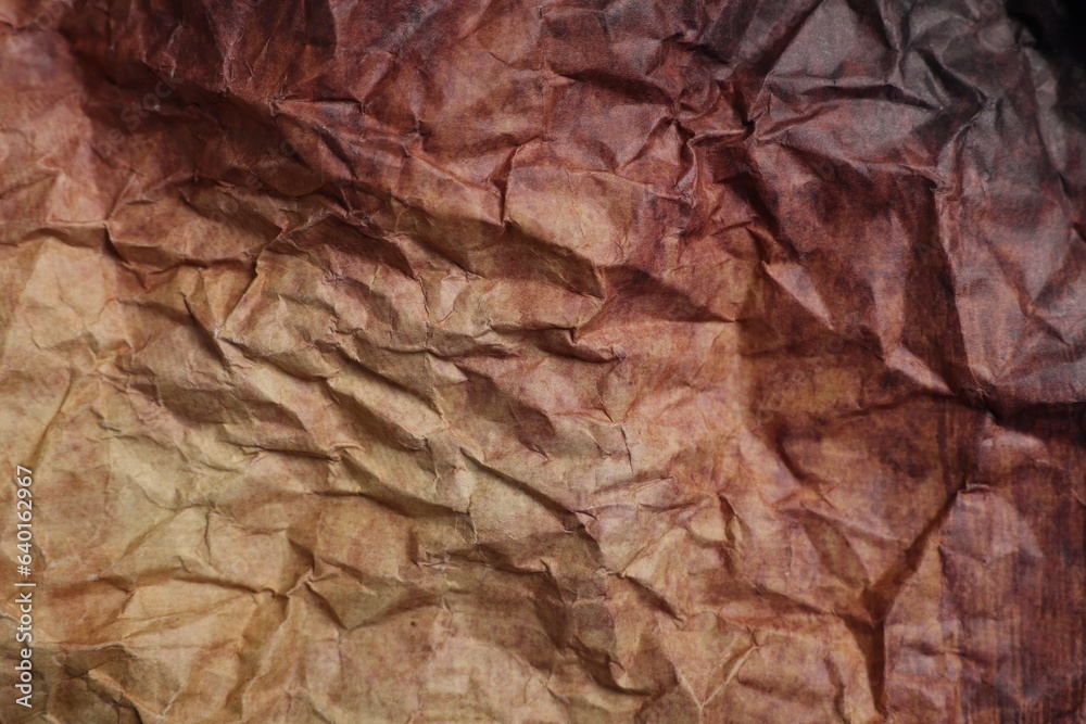 Naklejka premium Texture of crumpled parchment paper as background, top view