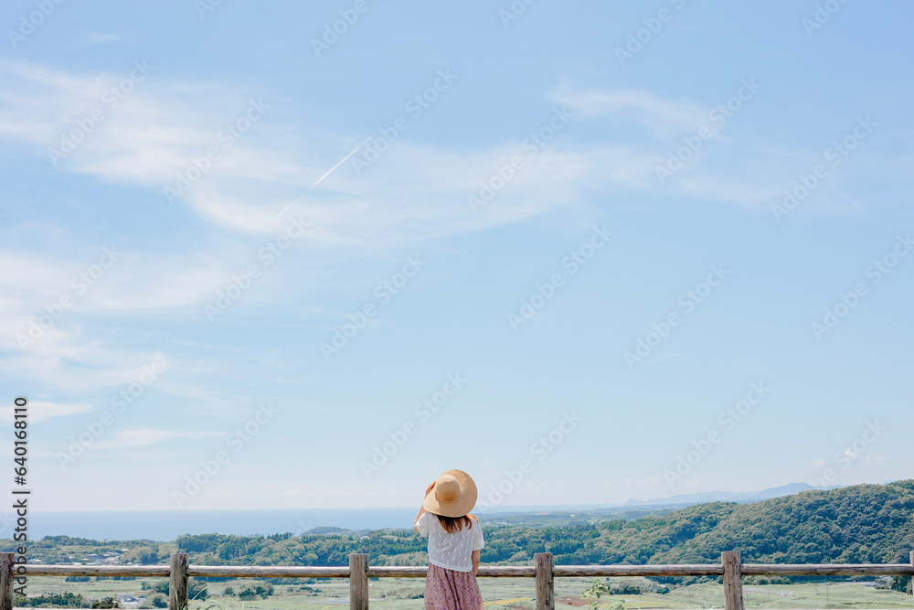 Japanese summer girl with straw hat at countryside.