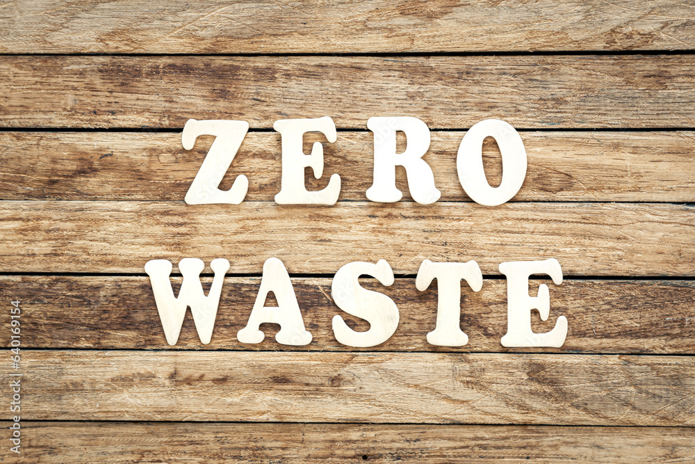 Zero waste written on wood letters on wooden background, top view. Zero waste written on wood letters on wooden background, top view.