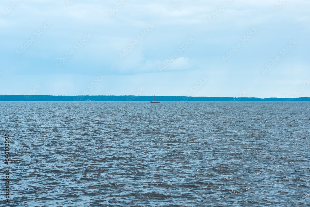 Obraz premium waterscape of Lake Onega, the silhouette of longship is visible in the distance