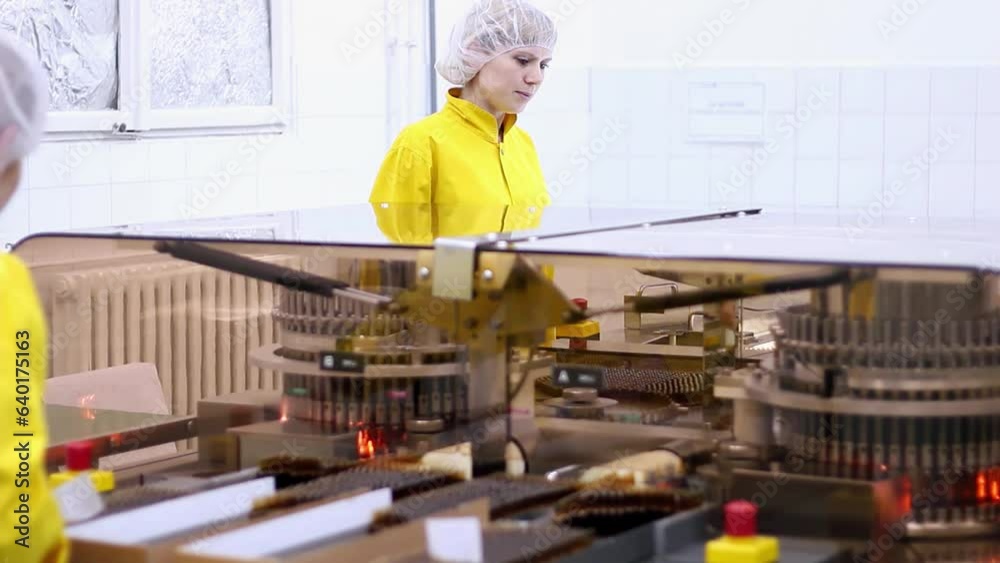 Two Pharmaceutical Female Workers Operating the Automatic Visual Inspection Machine for