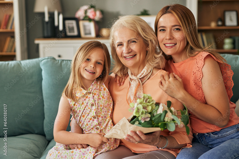 Happy three generation family celebrating grandmothers birthday portrait