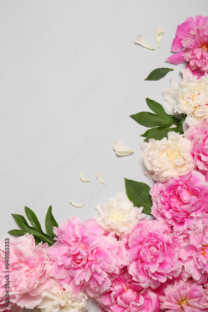 Beautiful peony flowers and green leaves on light grey background, flat lay. Space for text Beautiful peony flowers and green leaves on light grey background, flat lay. Space for text