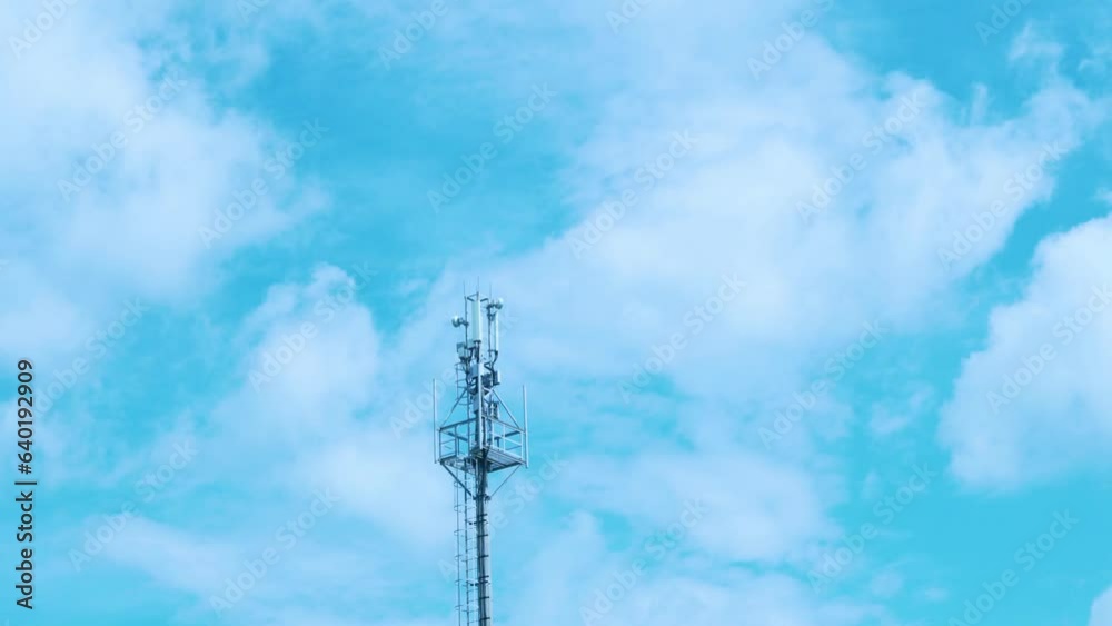Cellular Tower, 3g, 5g Transmitter, Cell Station Signal Cellular Communications and Timelapse Beautiful Puffy White Clouds in Blue Sunny Sky. Cellular Tower, 3g, 5g Transmitter, Cell Station Signal Cellular Communications and Timelapse Beautiful Puffy White Clouds in Blue Sunny Sky.