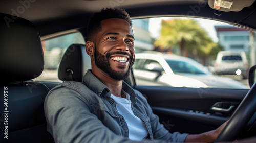 Man sits behind the wheel of a car and smiles © MP Studio
