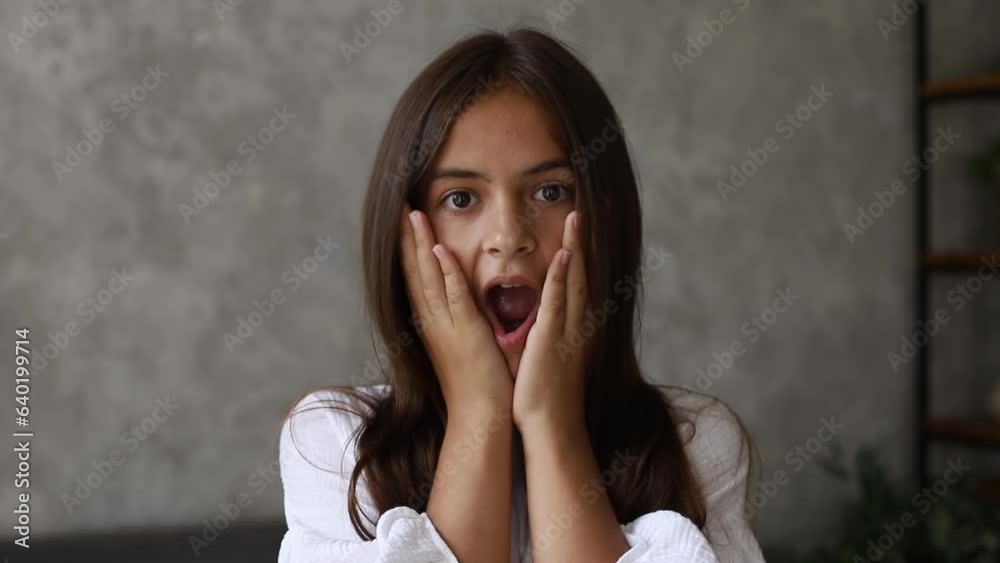 Teenager girl holding hands near face showing emotions of shock and surprise. Teenager girl holding hands near face showing emotions of shock and surprise.