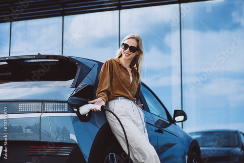 Woman charging electric car